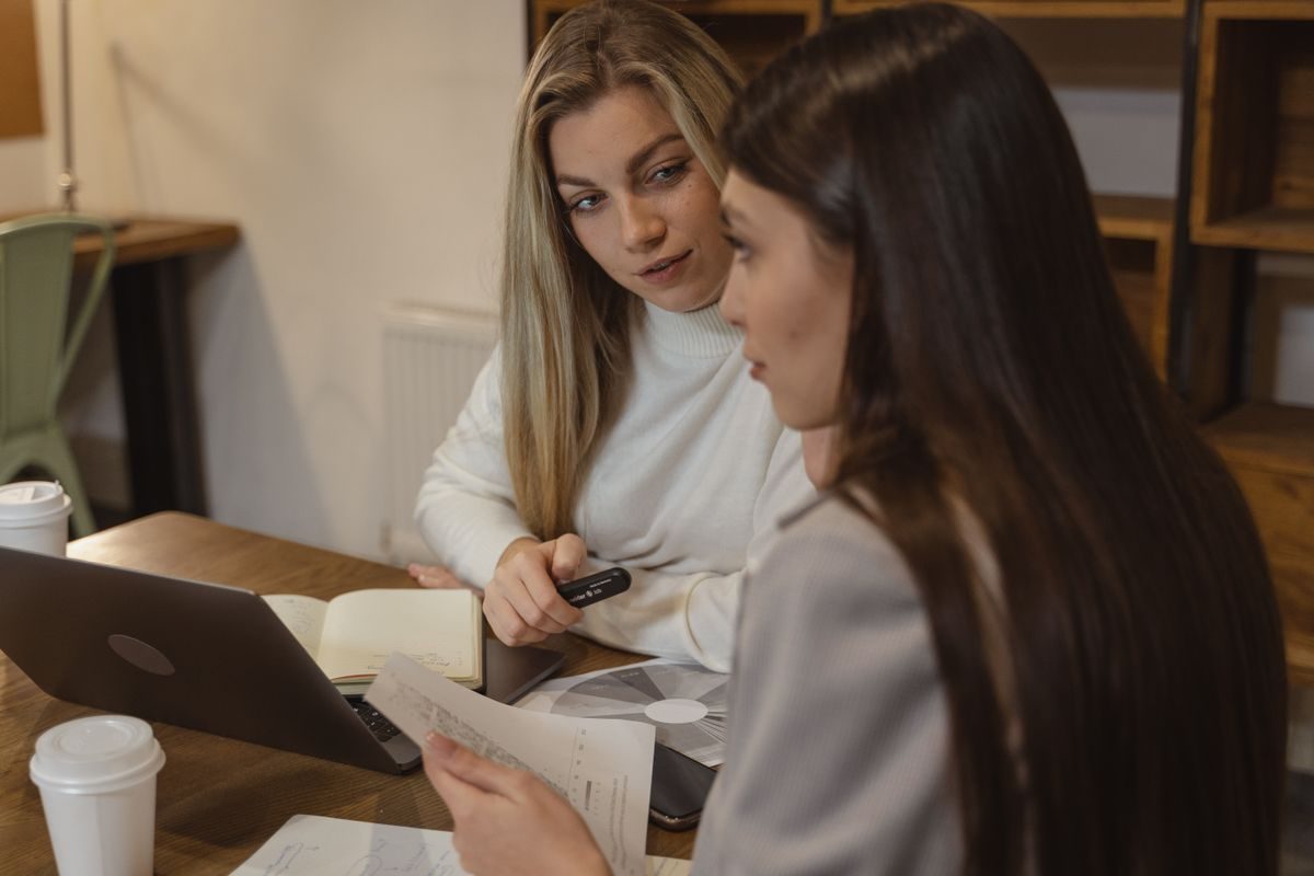 Two women going through work together